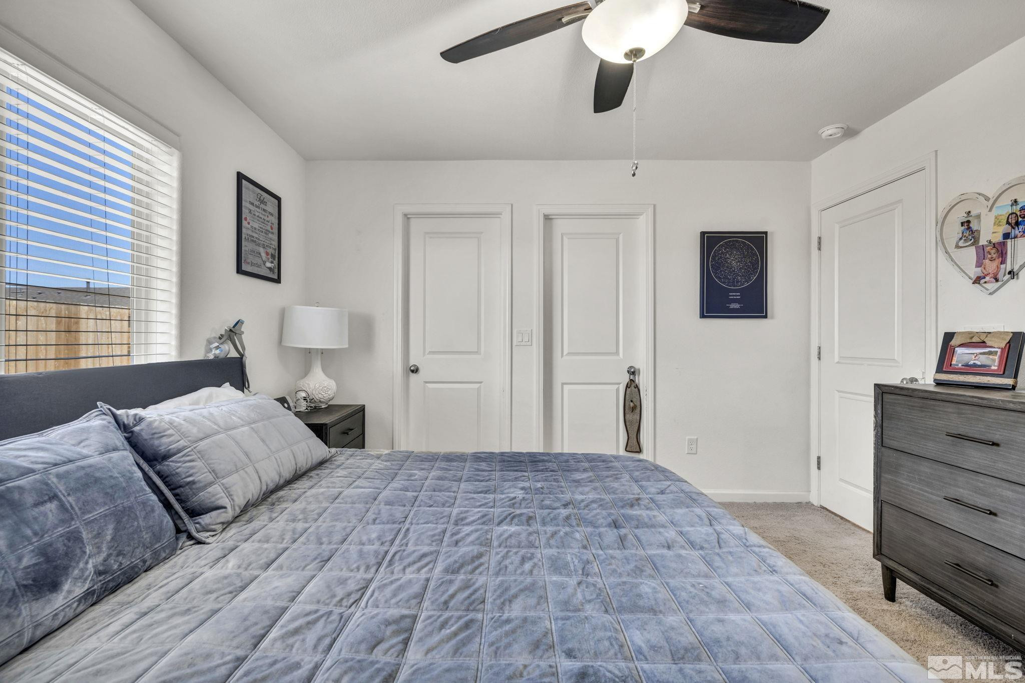 623 Yerington Drive Reno, NV 89506 - Photo 34 of 40 a bedroom with a bed and a chandelier