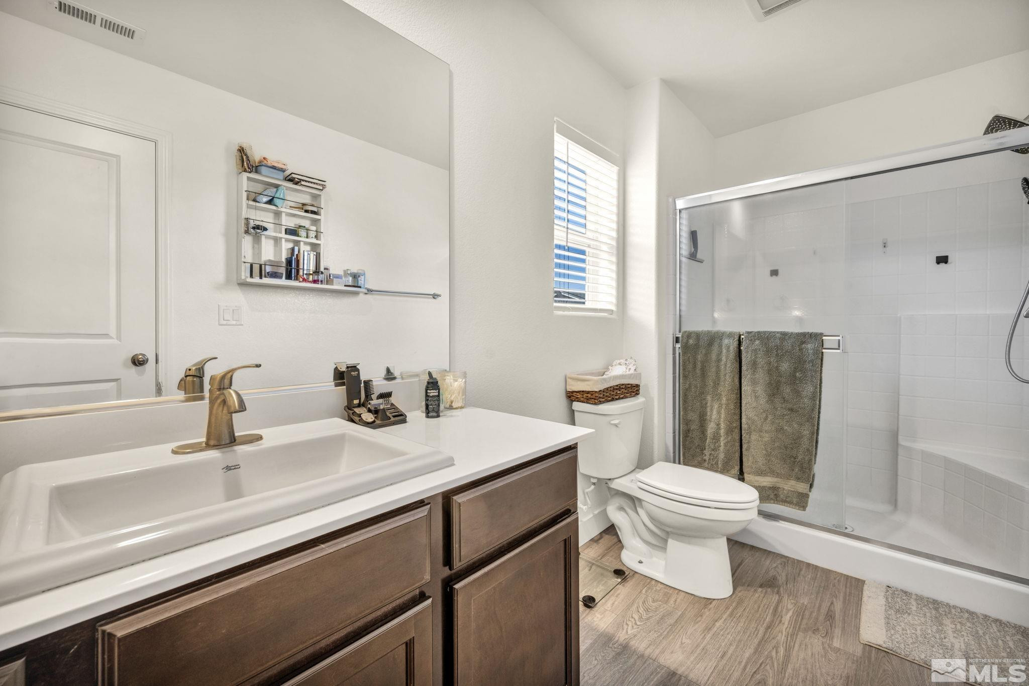 623 Yerington Drive Reno, NV 89506 - Photo 35 of 40 a bathroom with a sink a toilet a mirror and shower