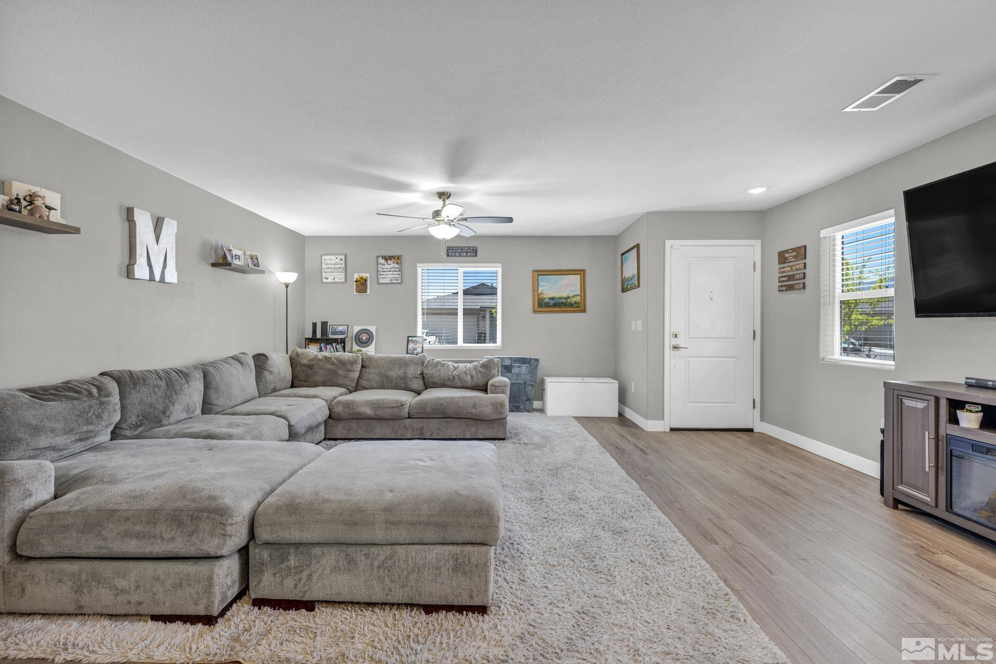 623 Yerington Drive Reno, NV 89506 - Photo 36 of 40 a living room with furniture a flat screen tv and kitchen view