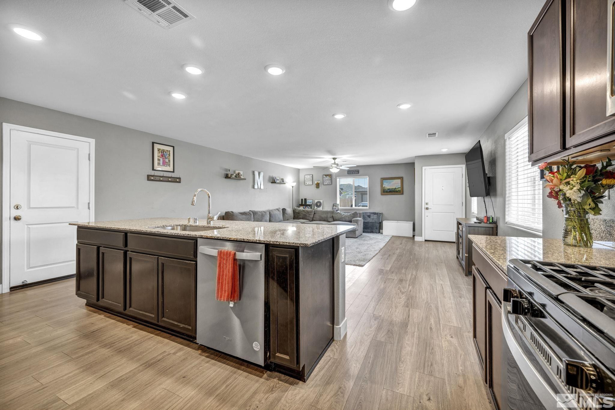 623 Yerington Drive Reno, NV 89506 - Photo 5 of 40 a kitchen with stainless steel appliances granite countertop a stove and a sink