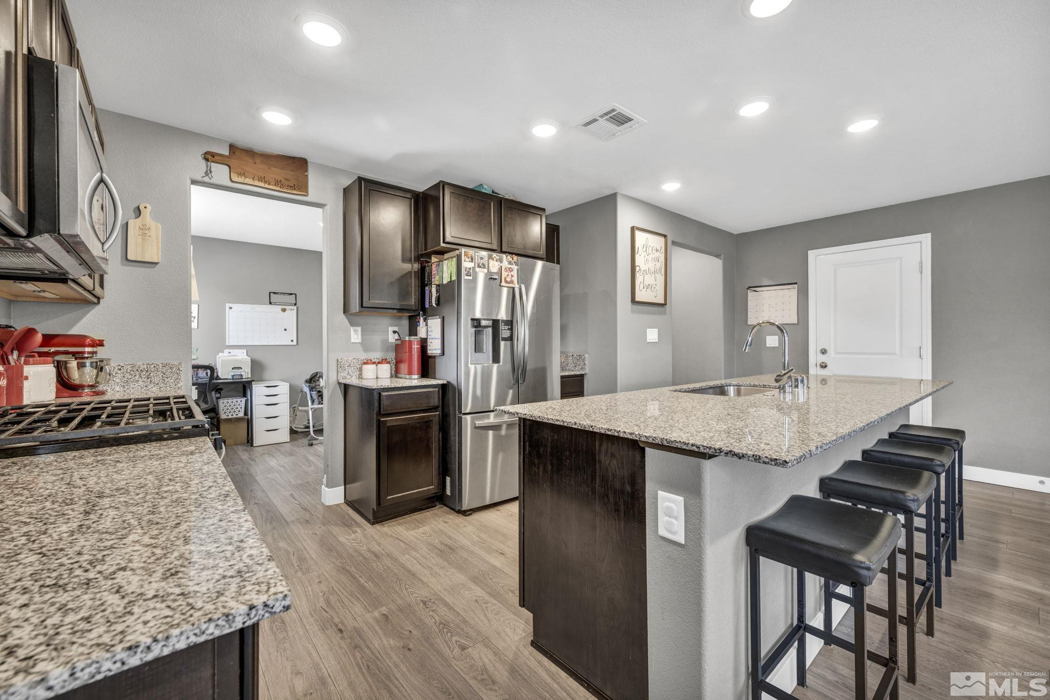 623 Yerington Drive Reno, NV 89506 - Photo 6 of 40 a kitchen with stainless steel appliances granite countertop sink stove top oven and refrigerator