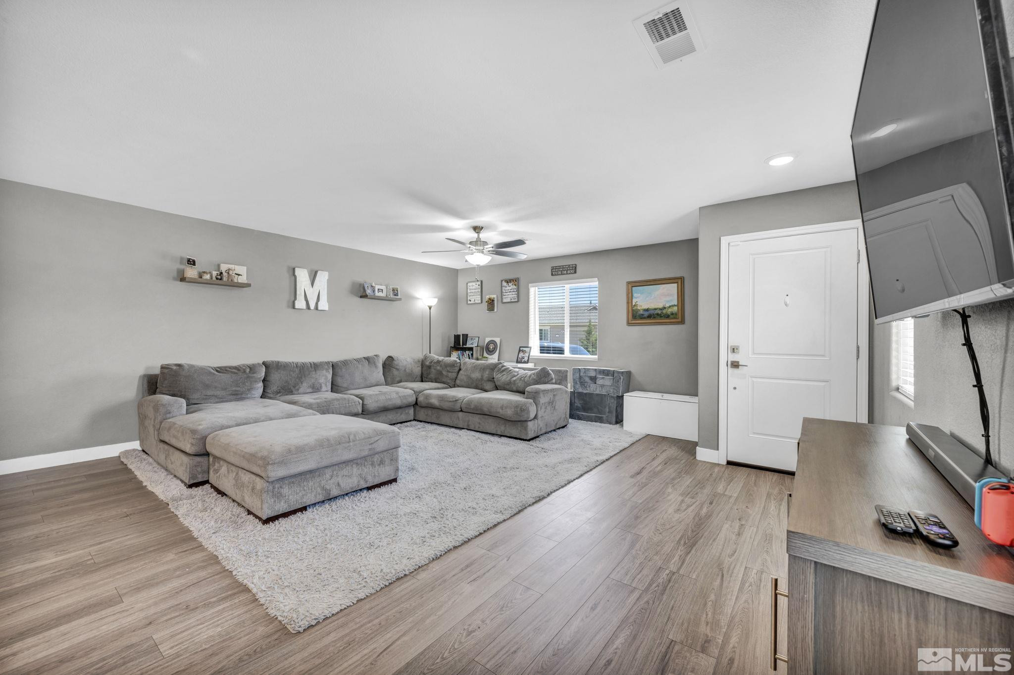 623 Yerington Drive Reno, NV 89506 - Photo 8 of 40 a living room with furniture flat screen tv and a wooden floor