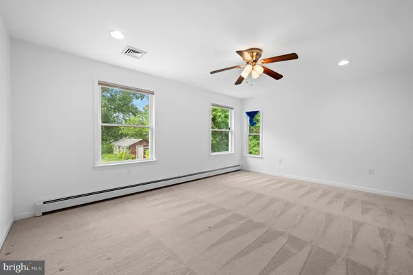 an empty room with window and wooden floor