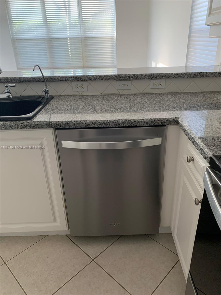 2145 Southwest 150th Avenue Miramar, FL 33027 - Photo 13 of 36 a kitchen with a sink and a stove