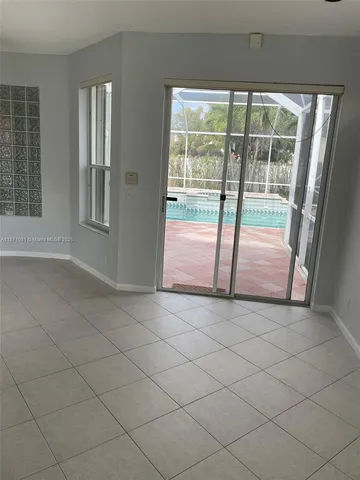 an empty room with sliding glass door and mountain view