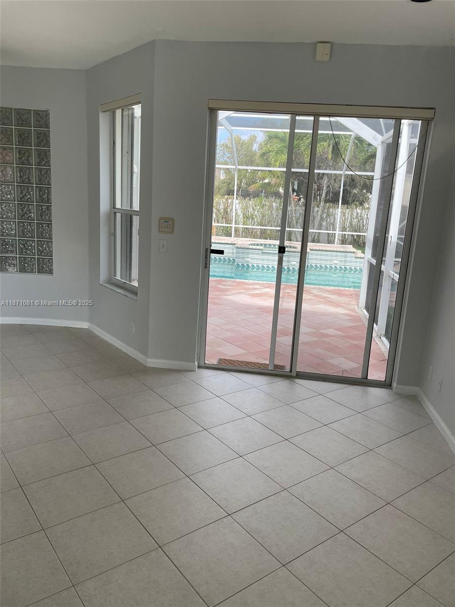 2145 Southwest 150th Avenue Miramar, FL 33027 - Photo 18 of 36 an empty room with sliding glass door and mountain view