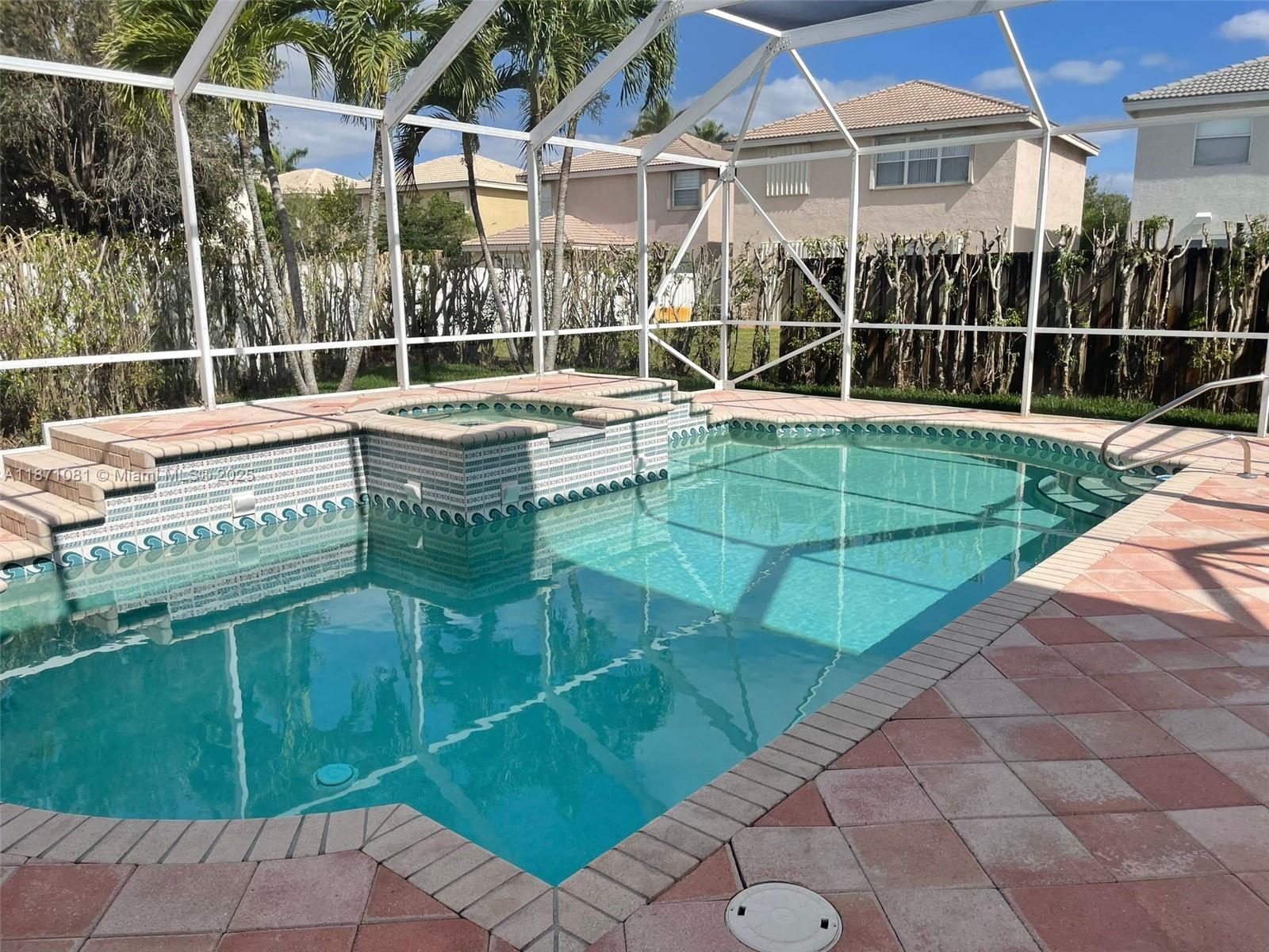 2145 Southwest 150th Avenue Miramar, FL 33027 - Photo 22 of 36 a view of a swimming pool with a porch