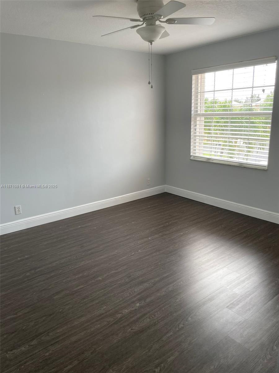 2145 Southwest 150th Avenue Miramar, FL 33027 - Photo 24 of 36 an empty room with wooden floor and windows