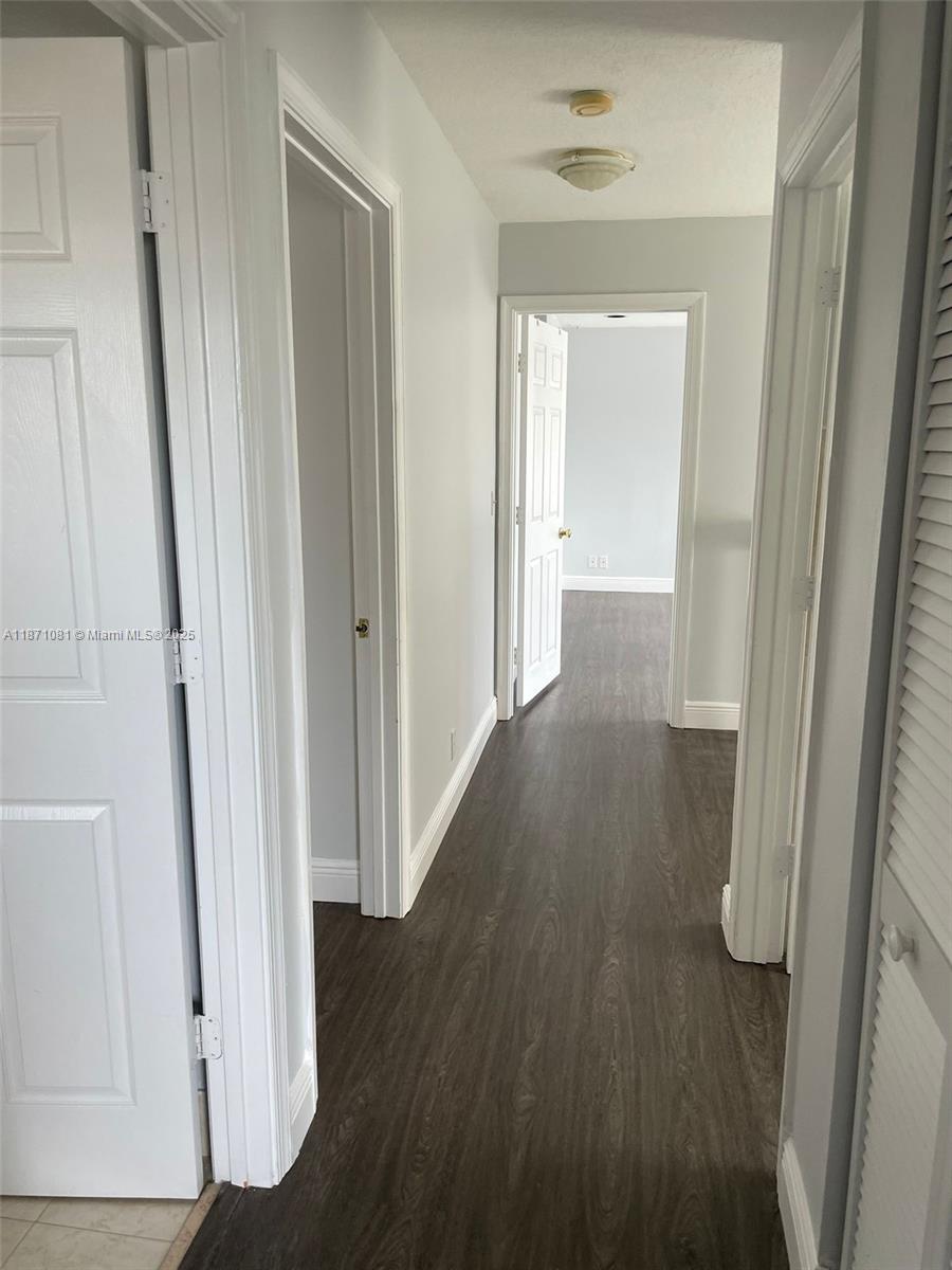 2145 Southwest 150th Avenue Miramar, FL 33027 - Photo 27 of 36 a view of a hallway with wooden floor