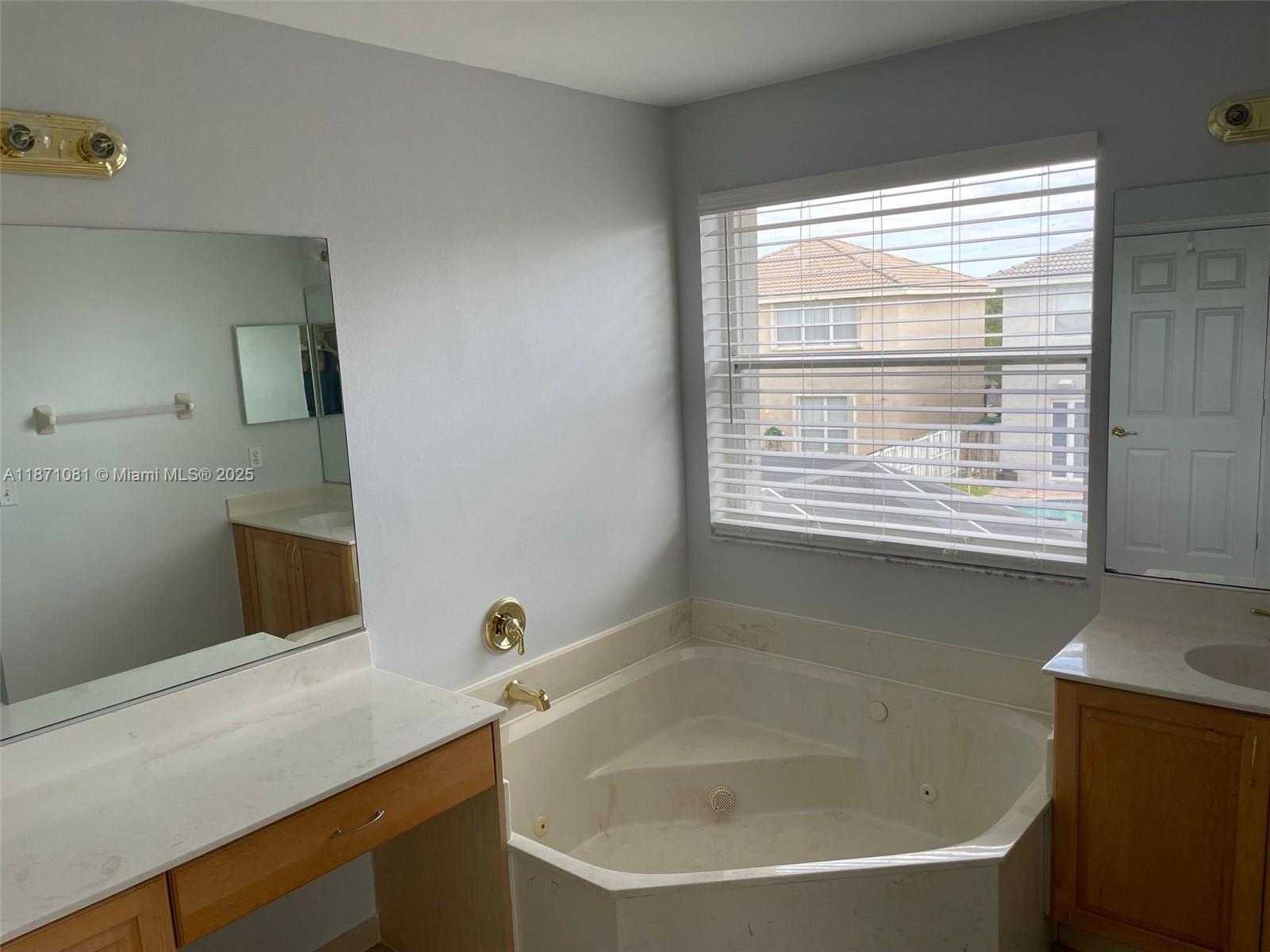 2145 Southwest 150th Avenue Miramar, FL 33027 - Photo 33 of 36 a bathroom with a bathtub and a window