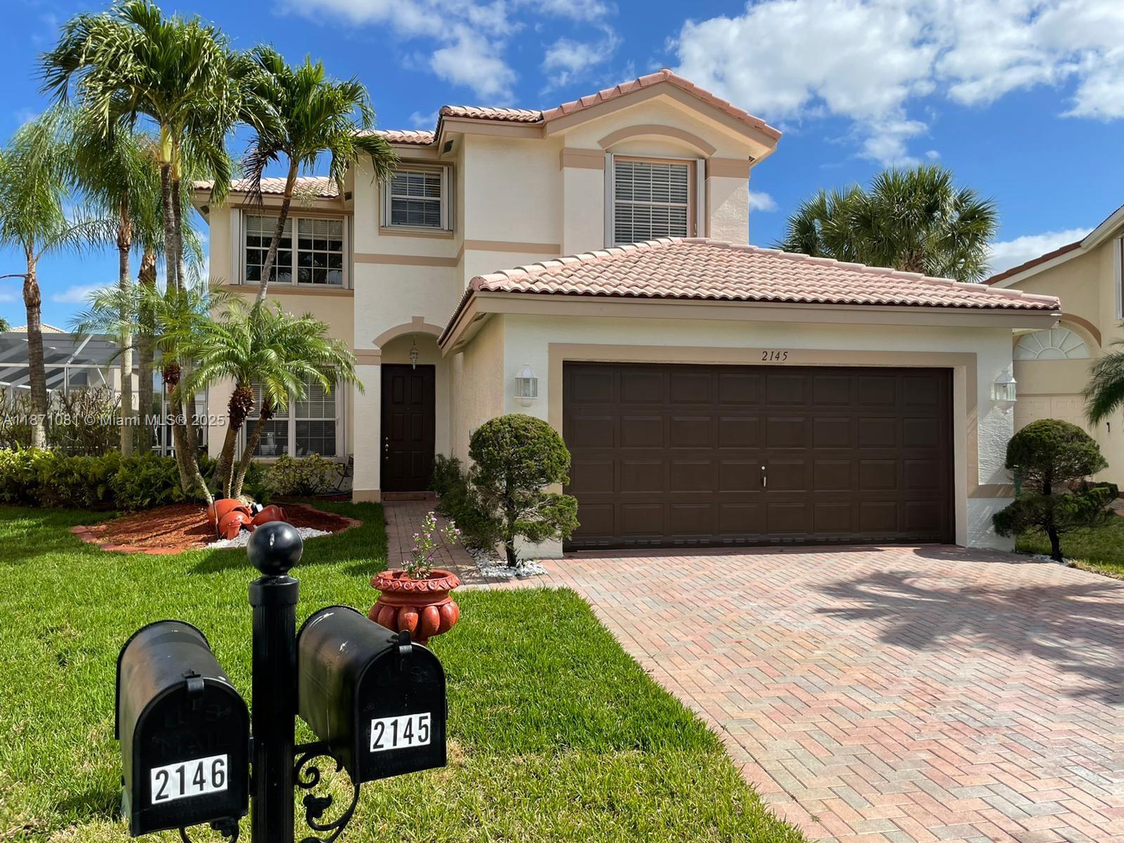 2145 Southwest 150th Avenue Miramar, FL 33027 - Photo 35 of 36 a front view of house with yard and green space