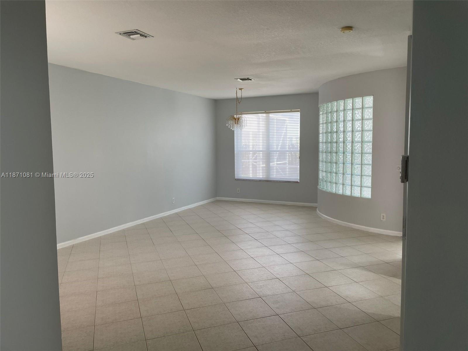 2145 Southwest 150th Avenue Miramar, FL 33027 - Photo 4 of 36 a view of an empty room with a window