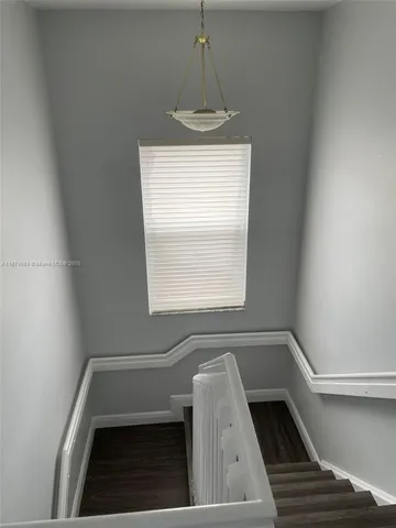 a view of empty room with a fireplace and windows