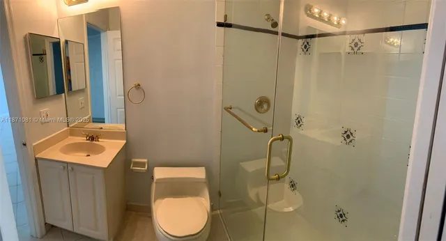 a bathroom with a shower sink and mirror