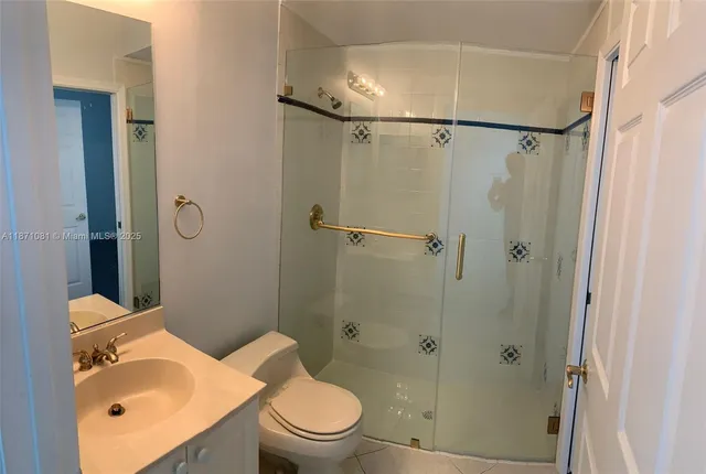 a white toilet sitting next to a bathroom sink