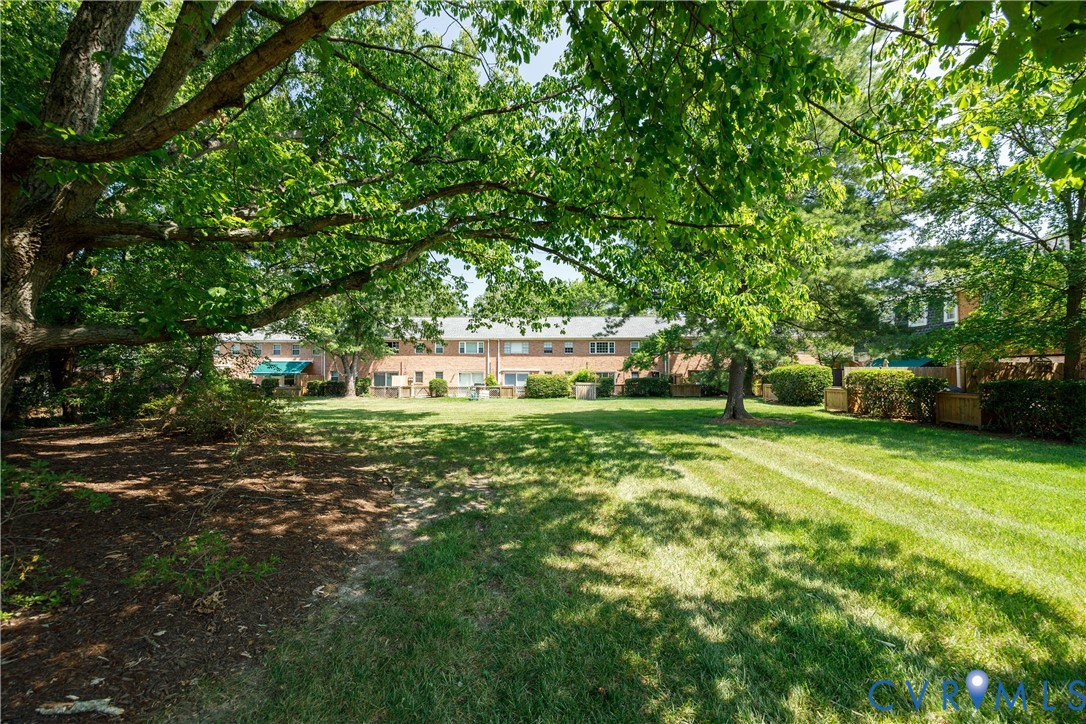 9129 Derbyshire Road, Unit E Henrico, VA 23229 - Photo 32 of 36 Expansive green space featuring mature trees and a