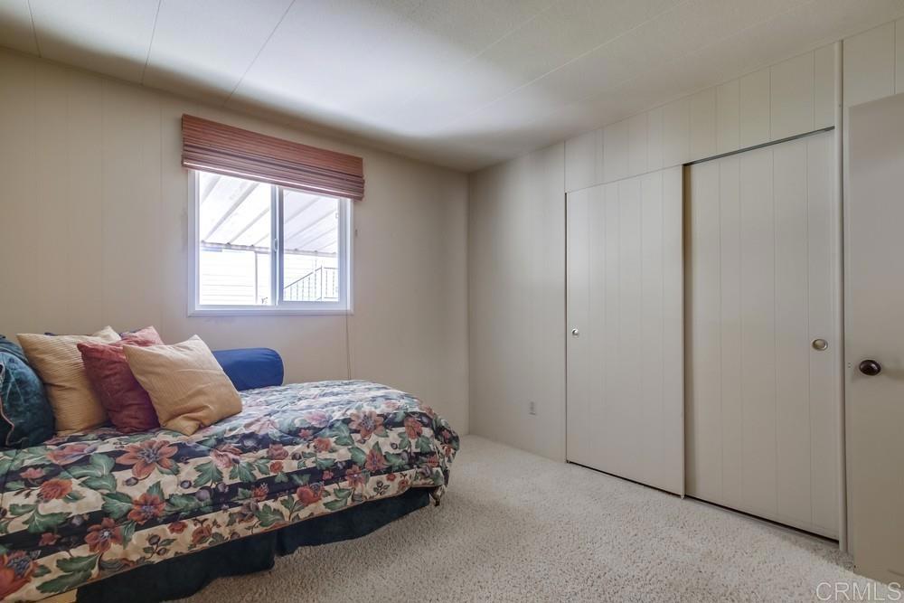 4993 Old Cliffs Road San Diego, CA 92120 - Photo 13 of 20 a bedroom with a bed and a window