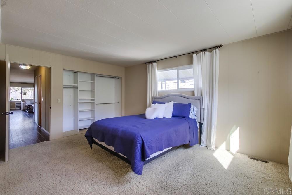4993 Old Cliffs Road San Diego, CA 92120 - Photo 14 of 20 a bedroom with a bed and a window