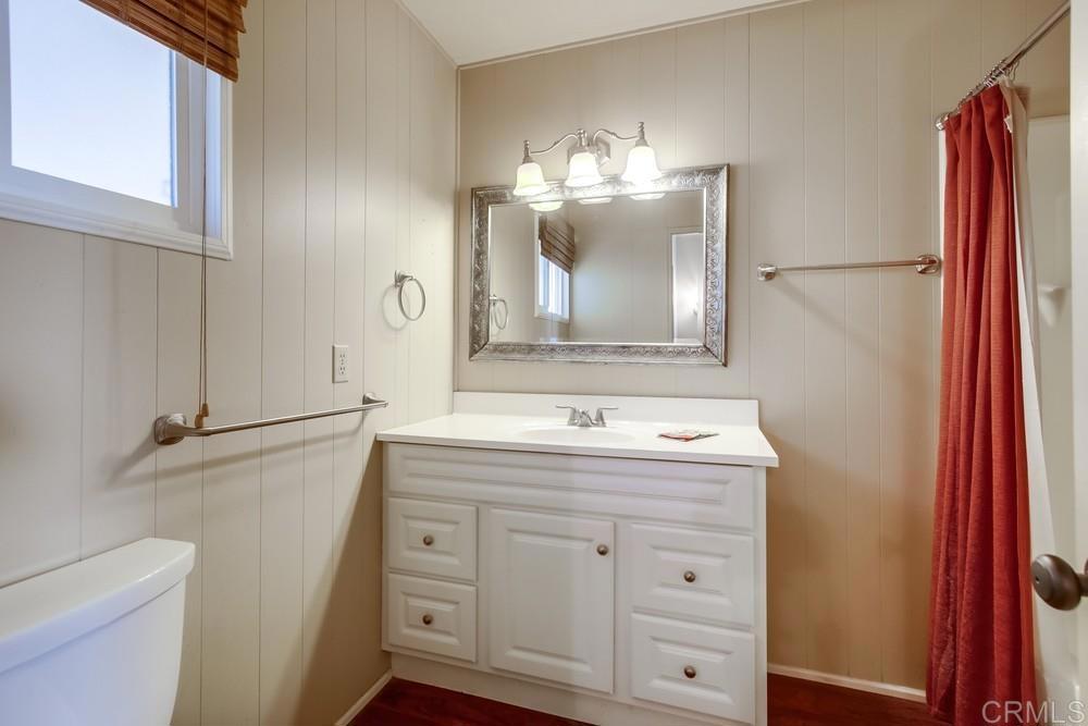 4993 Old Cliffs Road San Diego, CA 92120 - Photo 16 of 20 a bathroom with a double vanity sink and mirror