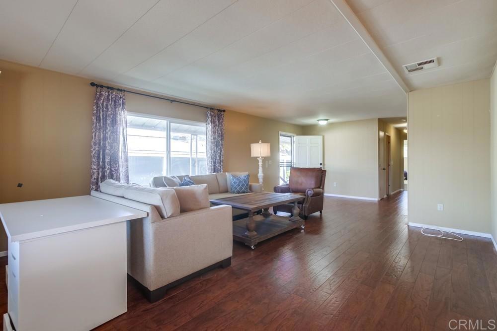 4993 Old Cliffs Road San Diego, CA 92120 - Photo 8 of 20 a living room with furniture and a wooden floor