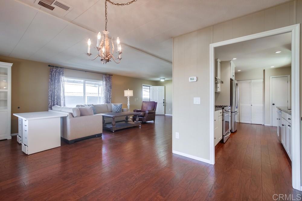 4993 Old Cliffs Road San Diego, CA 92120 - Photo 10 of 20 a living room with fireplace furniture and a wooden floor