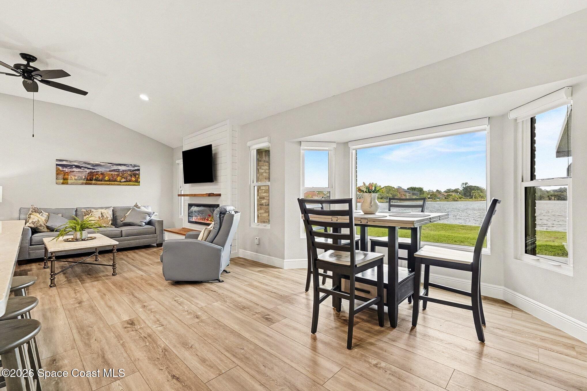 355 Lake View Lane Palm Bay, FL 32909 - Photo 14 of 49 a view of a dining room with furniture window and wooden floor