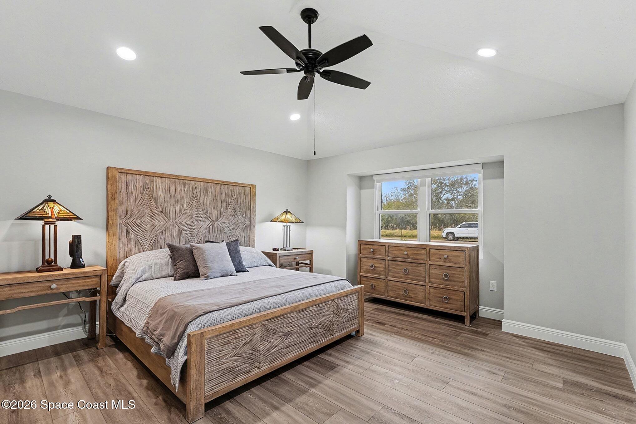 355 Lake View Lane Palm Bay, FL 32909 - Photo 17 of 49 a bedroom with bed and window