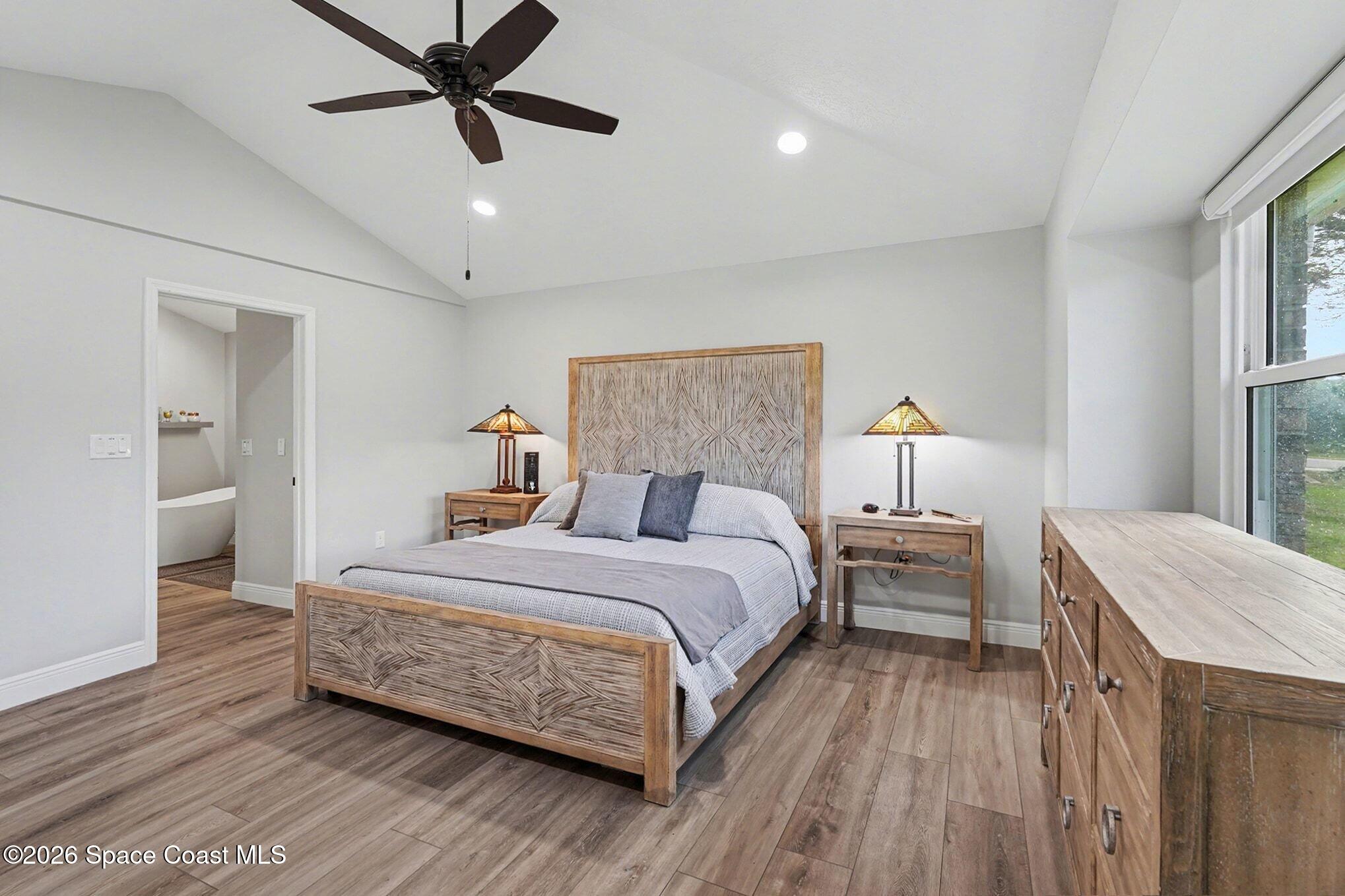 355 Lake View Lane Palm Bay, FL 32909 - Photo 18 of 49 a bedroom with a bed and a chandelier