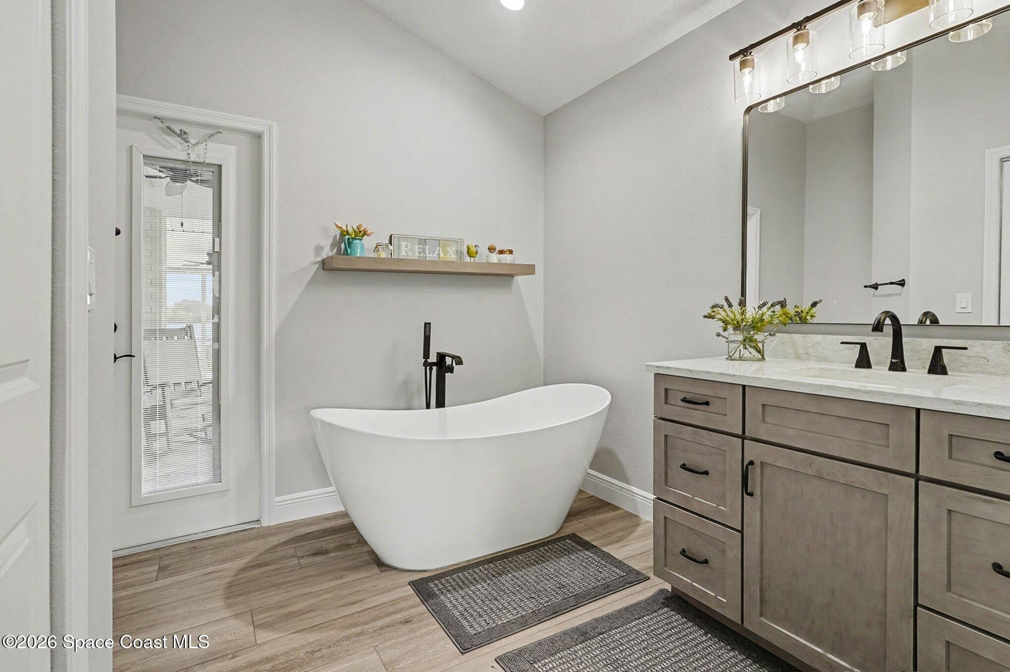 355 Lake View Lane Palm Bay, FL 32909 - Photo 20 of 49 a spacious bathroom with a sink and mirror