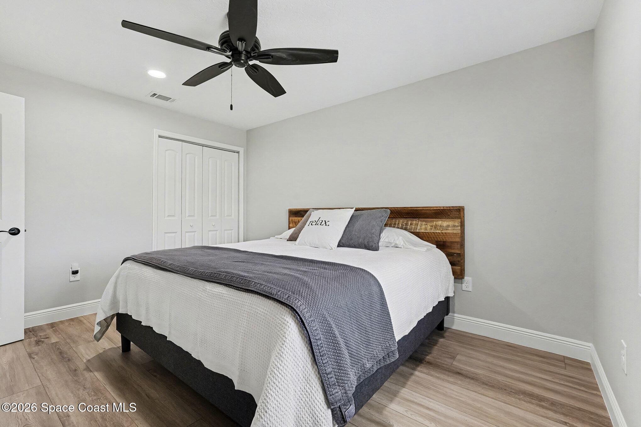 355 Lake View Lane Palm Bay, FL 32909 - Photo 23 of 49 a bedroom with a bed and a ceiling fan