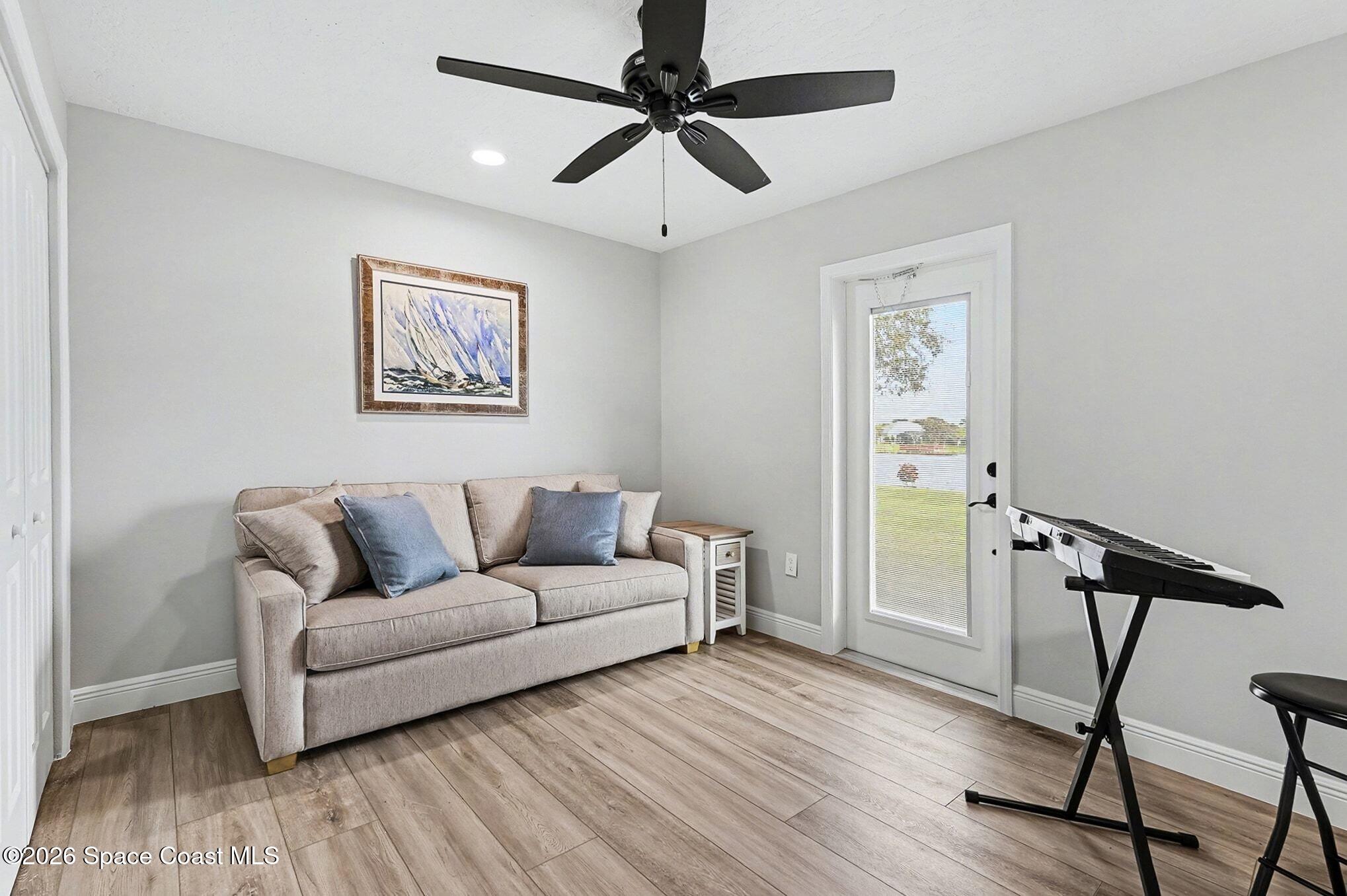 355 Lake View Lane Palm Bay, FL 32909 - Photo 24 of 49 a living room with furniture and a wooden floor