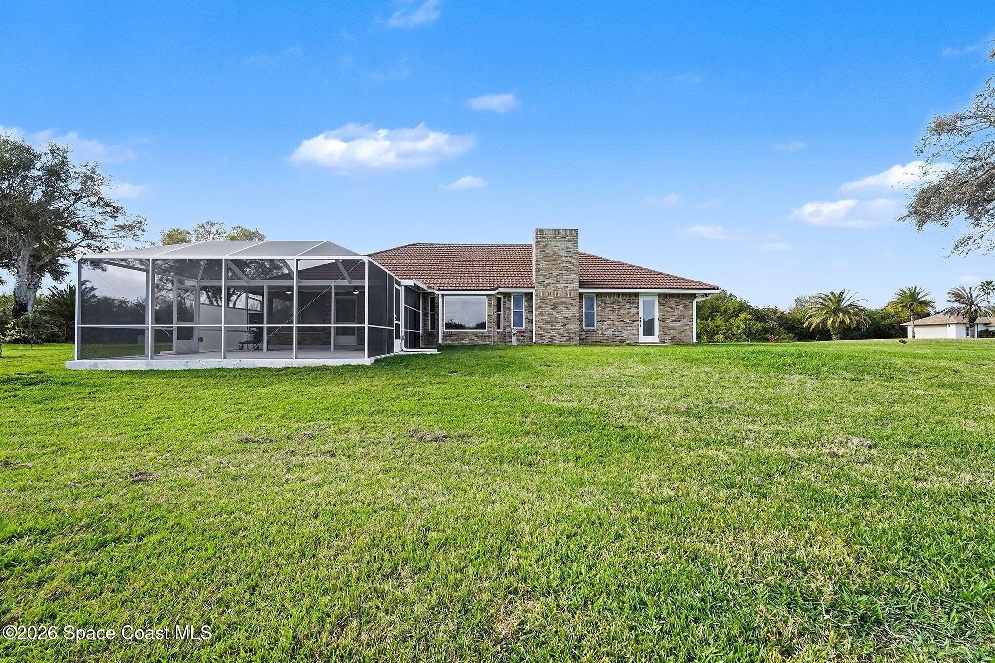 355 Lake View Lane Palm Bay, FL 32909 - Photo 44 of 49 a view of a house with a big yard and large trees