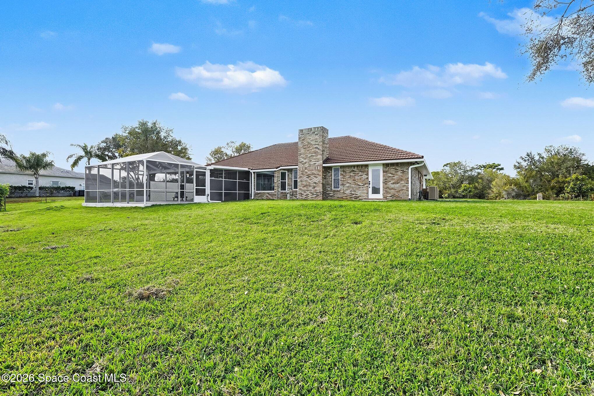 355 Lake View Lane Palm Bay, FL 32909 - Photo 45 of 49 a view of a house with a yard and sitting area