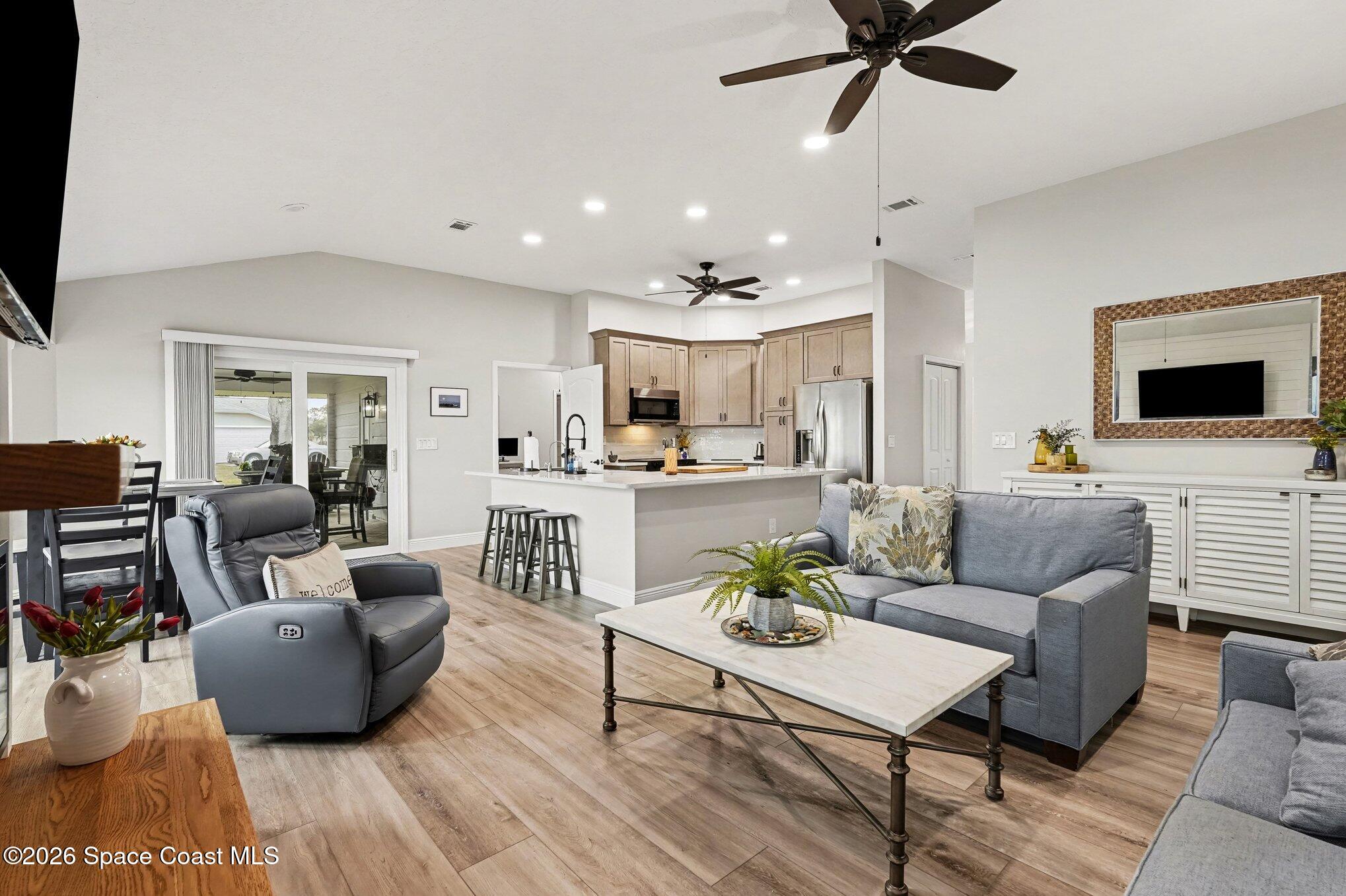 355 Lake View Lane Palm Bay, FL 32909 - Photo 8 of 49 a living room with furniture and a flat screen tv