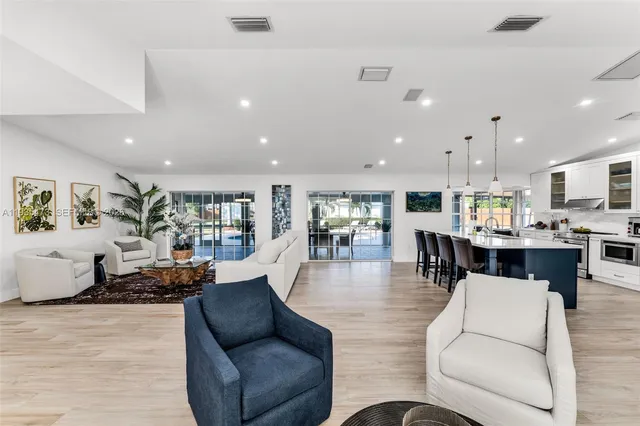 a kitchen with stainless steel appliances kitchen island granite countertop a sink counter space cabinets and a counter top space