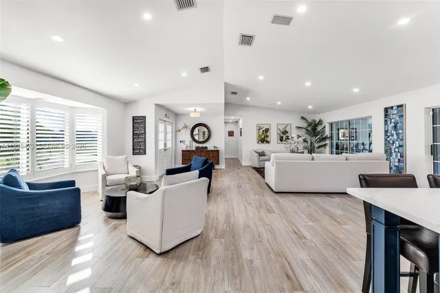 a kitchen with stainless steel appliances white cabinets and a refrigerator