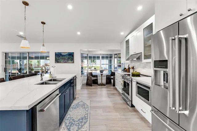 a bedroom with a large bed and a large window with wooden floor