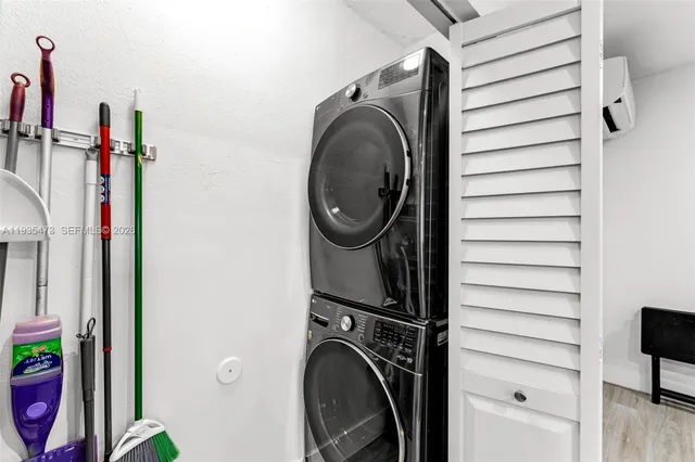 a kitchen with stainless steel appliances granite countertop a sink dishwasher and cabinets with wooden floor