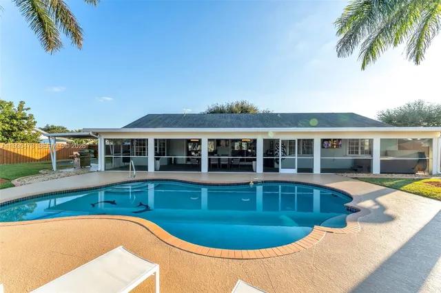 a view of a house with swimming pool and porch