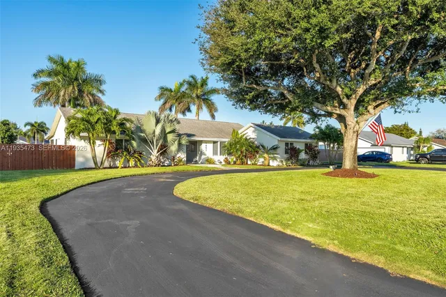 a living room with furniture kitchen view and large windows