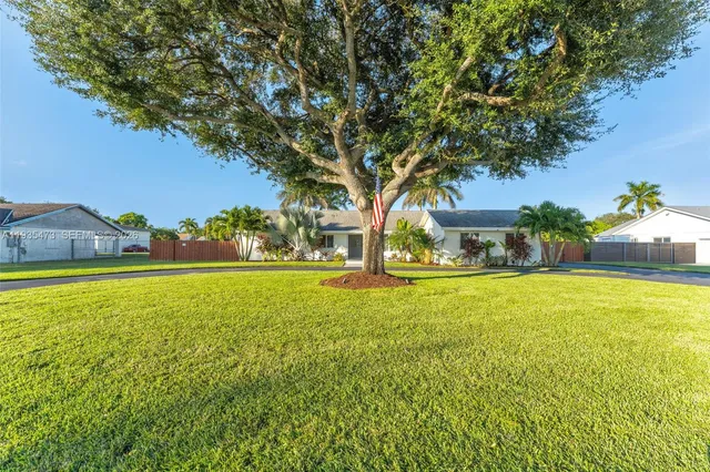 a living room with furniture wooden floor and a large window