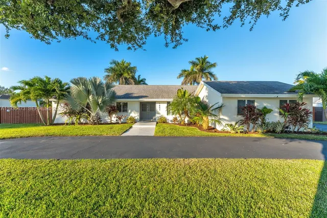 a living room with furniture wooden floor and a large window