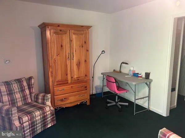 a living room with furniture and a dresser