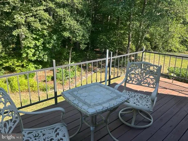 a view of balcony with wooden floor and outdoor seating
