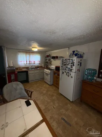 a kitchen with a stove and a refrigerator