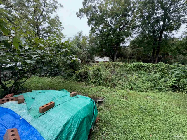 a view of a table and chairs in a backyard