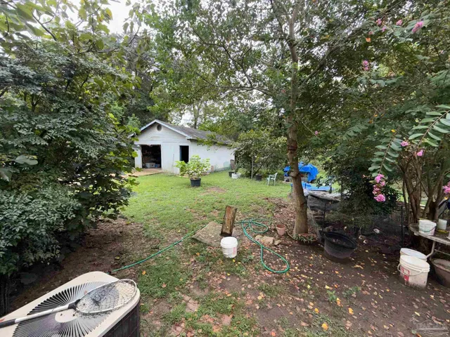 a view of a chair and tables in the backyard