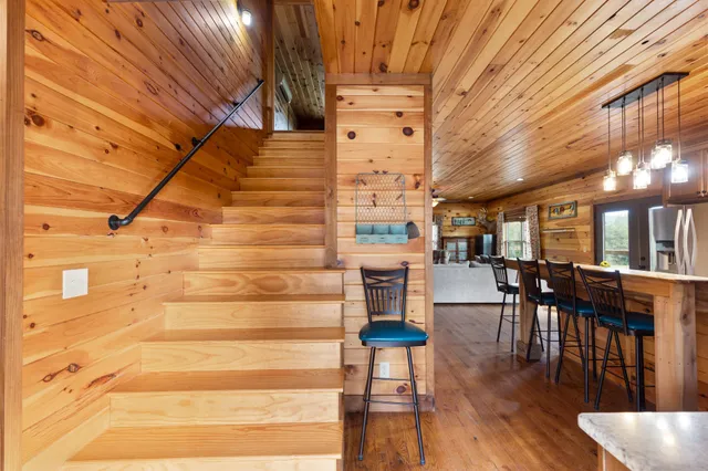 a kitchen with stainless steel appliances granite countertop a refrigerator a stove and a wooden floors