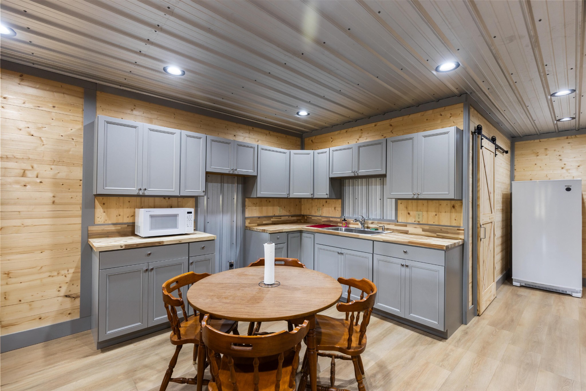 2054 Horns Creek Road Ocoee, TN 37361 - Photo 36 of 42 a kitchen with stainless steel appliances a table chairs sink refrigerator and cabinets