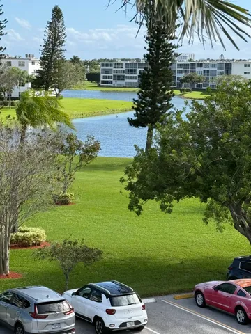 a view of a swimming pool and trees in the background